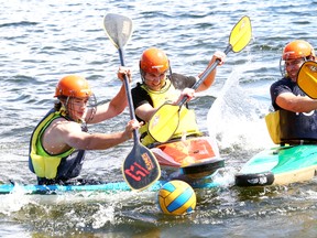 Tas Lanci, middle, trains for kayak polo with the help of his dad, Gergely, right, and Pete Boylan at the Northern Water Sports Centre in Sudbury, Ont. on Saturday June 4, 2016. John Lappa/Sudbury Star/Postmedia Network