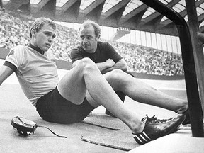 Canadian cyclist Jocelyn Lovell (left) talks to Olympic cycling team coach Barry Lycett at the Velodrome in Montreal in a July 20, 1976 file photo. Lovell, the three-time Olympian, has died at age 65. THE CANADIAN PRESS/Doug Ball