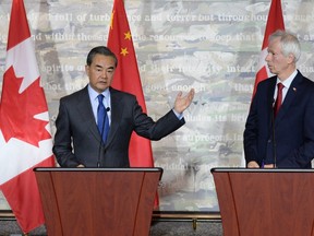 China's Minister of Foreign Affairs Wang Yi (left) and Canada's Minister of Foreign Affairs Stephane Dion participate in a press conference on Wednesday, June 1, 2016 in Ottawa. THE CANADIAN PRESS/Justin Tang