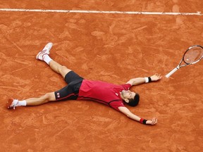 Serbia's Novak Djokovic falls as he defeats Britain's Andy Murray during their final match of the French Open tennis tournament at the Roland Garros in Paris on June 5, 2016. (AP Photo/David Vincent)