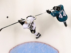 Pittsburgh Penguins center Sidney Crosby (87) skates in front of San Jose Sharks defenseman Marc-Edouard Vlasic (44) during the third period of Game 3 of the NHL hockey Stanley Cup Finals in San Jose, Calif., Saturday, June 4, 2016. (AP Photo/Marcio Jose Sanchez)