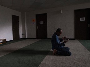 Mohamud Alihashi prays at the Markaz Ul Islam mosque after returning to Fort McMurray on June, 1 2016.
