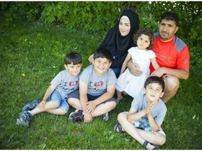 From left, Zeid Alsebai, 5, Abdullah, 7, mother Nirmeen Alsebai, father Jehad Alsebaee, holding Lyana, 3, and Mohamed, 7, a Syrian family who arrived in Canada five months ago, are settling in to their new lives. ASHLEY FRASER / .