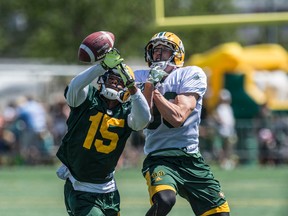 Defensive back Deion Belue tips the ball away from receiver Chris Getzlaf. Eskimos Fan Day Saturday at Clarke Park featured a team practice and then an autograph session with the players. (Shaughn Butts )
