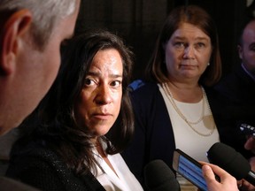 Minister of Justice Jody Wilson-Raybould and Health Minister Jane Philpott, right, talk to reporters outside the House of Commons on Tuesday May 31, 2016 in Ottawa. Wilson-Raybould likes to cite the case of E.F. when she warns of the danger that will exist as of 12:00 a.m. Monday, when medically assisted dying becomes legal in Canada without safeguards. THE CANADIAN PRESS/Fred Chartrand
