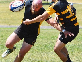 Trenton ballcarrier Riley Avery takes on a Kingston LaSalle defender during gold-medal final action at the OFSAA AA boys rugby championship last weekend at Cobourg. (Catherine Frost for The Intelligencer)