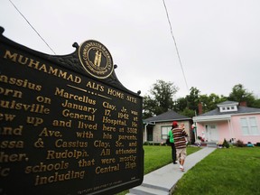 People visit Muhammad Ali's childhood home in Louisville, Ky., where he grew up as Cassius Clay, on Sunday. (AP Photo)