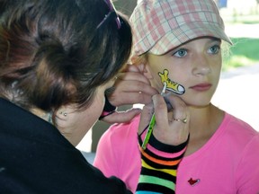 Janelle Pennings, 9, of Mitchell, sat stoicly as artist Erin Porter (left), of St. Thomas, paints the JDRF (Juvenile Diabetes Research Foundation) shoe on her cheek prior to the beginning of the 9th annual JDRF walk in Mitchell’s Lions Park this past Saturday, June 4. Janelle was walking for her grandfather Ron, and uncle Greg, one of 20 teams of fundraisers from Perth and Huron Counties to participate. ANDY BADER MITCHELL ADVOCATE