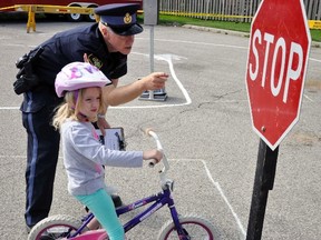 A record number of participants, 76, drove their way to the Mitchell town hall for the Optimist Club of Mitchell’s annual Bike Rodeo. Perth County OPP Const. Kees Wijnands gave instructions to Rhyse McCracken, 6, at a stop sign at the beginning of the course. Brain and Mind Matters (BAMM) were able to assist the OPP and the Optimists this day, and they handed out 27 helmets given away by the charity, their second year doing so. ANDY BADER MITCHELL ADVOCATE