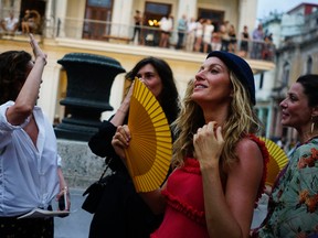Brazilian top model Gisele Bundchen, second right, attends the presentation of Fashion designer Karl Lagerfeld's "cruise" line for fashion house Chanel, at the Paseo del Prado street in Havana, Cuba, Tuesday, May 3, 2016.  (AP Photo/Ramon Espinosa)