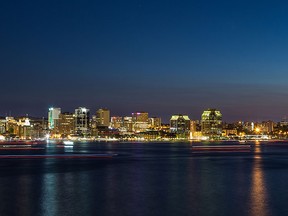 A view of Halifax waterfront at night. The trail of Boats can be seen in the water. (mikeinlondon/Getty Images)