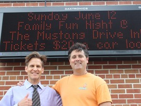 Park Dale Public School principal Derek DeLarge and community representative for the school and Belleville police officer, Todd Bennett stand outside Park Dale Monday afternoon. The school is raising money to pay for the electronic sign that was installed outside the school with a movie night at The Mustang Drive-In on June 12.
