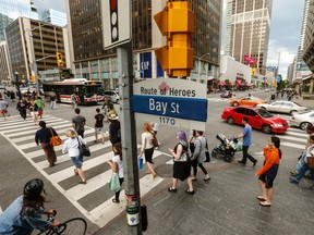 The intersection of Bay St. and Bloor St. W. will be one of eight intersections in Toronto that will receive “traffic assistant personnel” as part of a pilot project that begins June 13.  (Jack Boland/Toronto Sun)