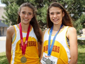 Brogan MacDougall, left, won gold in the junior girls 3,000 metres and older sister Branna won silver in the senior girls 3,000 metres at the Ontario Federation of School Athletic Associations track and field championships in Windsor on the weekend. (Julia McKay/The Whig-Standard)