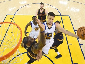 Golden State Warriors guard Stephen Curry (30) shoots against Cleveland Cavaliers forward LeBron James during the first half of Game 2 of basketball's NBA Finals in Oakland, Calif., Sunday, June 5, 2016. (Bob Donnan, USA TODAY Sports Pool via AP, Pool)