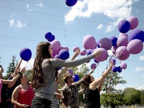 Kenzie Ludington, a Grade 11 student from St. Mary's Catholic High School in Woodstock, releases purple balloons into the air over Southside Pond with other students from Woodstock area schools.
The balloon release was a tribute to the five local teens who have committed suicide in recent months. 
BRUCE CHESSELL/Sentinel-Review
Shown in Woodstock, Ont. on Monday June 6, 2016. Bruce Chessell/Woodstock Sentinel-Review/Postmedia Network