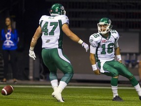 Saskatchewan Roughriders QB Brett Smith, No. 16, celebrates his touchdown against the B.C. Lions with Matthew Rea during a game in Vancouver last July. (REUTERS)
