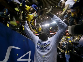 Golden State Warriors forward Draymond Green greets fans after the Warriors beat the Cleveland Cavaliers in Game 2 of basketball's NBA Finals in Oakland, Calif., Sunday, June 5, 2016. The Warriors won 110-77. (AP Photo/Marcio Jose Sanchez)