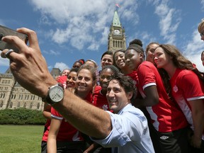 Canada's women's national soccer team got a big surprise from Prime Minister Justin Trudeau while taking some time to relax and enjoy the afternoon on Parliament Hill in Ottawa on Monday, June 6, 2016. (Tony Caldwell/Postmedia)