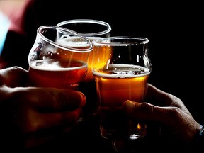 In this file photo, customers clink their glasses while drinking beer. (Justin Sullivan/Getty Images)