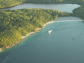 A Blue Heron tour boat cruises through the coastline of the Bruce Peninsula National Park. Racers are transported to Flowerpot Island aboard a Blue Heron craft as part of the 5K run that takes place on the island. Kelsey Dickinson photo.