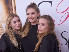 Elizabeth Olsen (center) and Mary-Kate and Ashley Olsen attend the 2016 CFDA Fashion Awards at the Hammerstein Ballroom on June 6, 2016 in New York City.  Jamie McCarthy/Getty Images/AFP