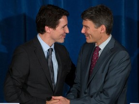 Prime Minister Justin Trudeau, left, and Vancouver Mayor Gregor Robertson shake hands after a news conference in Vancouver, B.C., on Thursday December 17, 2015. Trudeau's visit to Vancouver City Hall was the first by a prime minister since his father, former prime minister Pierre Trudeau visited in 1973. THE CANADIAN PRESS/Darryl Dyck