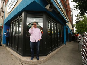 Zane Caplanksy stands outside his shutdown Caplanksy's Deli restaurant on College St. W. Tuesday June 7, 2016 after his landlord pinned a bailiff's notice on his front door June 6. (Jack Boland/Toronto Sun)