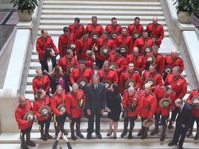 Premier Brian Pallister and Justice Minister Heather Stefanson pose for a photo with members of the RCMP following a ceremony on Tuesday, where Mounties received the Order of the Buffalo Hunt for assisting during the Fort McMurray fire. (Brian Donogh/Winnipeg Sun)