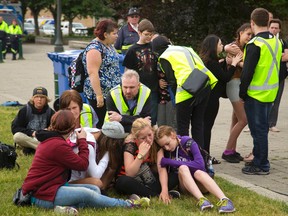 Workers from the Canadian Mental Health Association talk to distraught students during Tuesday's walkout of secondary school students in Woodstock to support the need for more mental health resources. (MIKE HENSEN, The London Free Press)