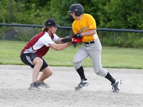 St. Charles Cardinals’ Blake Purcell puts a tag on Notre Dame Alouettes’ Cameron Mostoway during the boys city championship slo-pitch game at the Centennial baseball diamonds in the Valley on Tuesday.