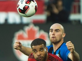Toronto FC forward Jordan Hamilton (left) battles for the ball against Montreal Impact midfielder Jeremy Gagnon-Lapare during their Canadian Championship match last week. (CP)