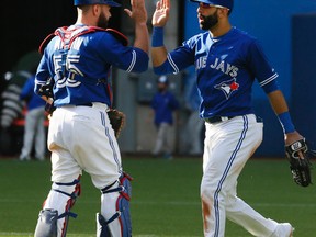 Russell Martin (left) and Jose Bautista of the Toronto Blue Jays. (STAN BEHAL/Toronto Sun)