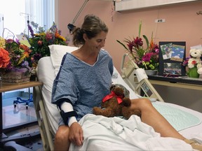 Maria Korcsmaros recovers from a shark attack in her hospital bed at Orange County Global Medical Center in Santa Ana, Calif., on Tuesday, June 7, 2016. The teddy bear next to her is wearing the swim goggles she used when she was bitten by a shark off the Orange County coast last month. (AP Photo/Amy Taxin)