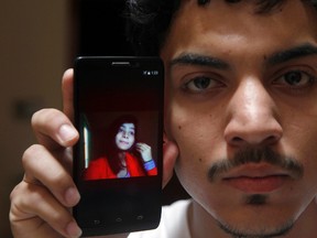 Hassan Khan shows the picture of his wife Zeenat Rafiq, who was burned alive, allegedly by her mother, on a cellphone at his home in Lahore, Pakistan, on June 8, 2016. (AP Photo/K.M. Chaudary)