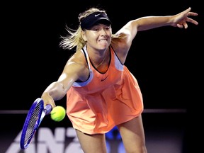 Maria Sharapova hits a forehand return to Lauren Davis during their third-round match at the Australian Open in Melbourne Friday, Jan. 22, 2016.(AP Photo/Aaron Favila)