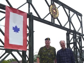 Chairman of the 91st Battalion C.E.F. 100th anniversary organizing commitee Hon. Lt.-Col. Mark Sargent, left, and Elgin County Museum curator Mike Baker, unfurl a replica service flag at the armouries Tuesday morning. The pair are hoping community members will display their own replica service flags in their house windows as a show of support for the centennial anniversary June 24 to 26.