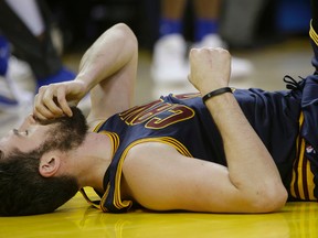 Cleveland Cavaliers forward Kevin Love remains on the floor after a play during the first half of Game 2 of the NBA Finals between the Golden State Warriors and the Cavaliers in Oakland on June 5, 2016. (AP Photo/Marcio Jose Sanchez)