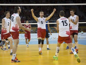 Canadian teammates John Gordon Perrin, Nicholas Hoag, Rudy Verhoff, Frederic Winters and Gavin Schmitt celebrate during the men's volleyball bronze-medal match against Puerto Rico at the Pan American Games in Toronto on July 26, 2015. (AFP PHOTO/KEVIN VAN PAASSEN)