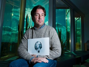 Sean McCowan poses holding a photo of his sister -- Erin Gilmour -- at his office in downtown Toronto Dec. 28, 2011. More than 30 years after his sister Erin Gilmour was murdered in Hazelton Lanes, McCowan is hopeful her killer can be brought to justice. (Ernest Doroszuk/Toronto Sun files)