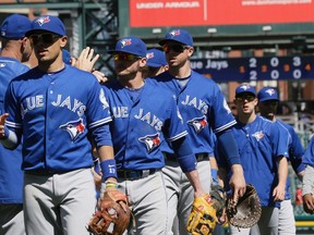 The Toronto Blue Jays walk off the field after their 7-2 win over the Detroit Tigers in a baseball game, Wednesday, June 8, 2016, in Detroit. (AP Photo/Carlos Osorio)