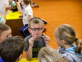 Vermilion Elementary School Grade 1 student Jett Wilson reacts to the taste of a taste strip, during a Let's Talk Science program on senses at the Vermilion Public Library on Tuesday, May 31.