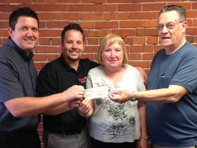 Wallaceburg Fireworks Committee members Kevin Roocroft, left, and Tom Cogghe, receive a cheque for $1,500 from Wallaceburg Optimist members Marg Blair and Eric Johnston. Preparations are under way for the Canada Day celebrations. Upcoming fundraisers for the committee include an online auction later this month.