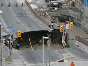 A large portion of Rideau Street in downtown Ottawa, Ontario is seen caved in, causing a massive sinkhole that knocked out power to the majority of the downtown area on June 8, 2016. (Chris Roussakis/AFP)