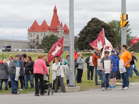 Members of the Union of Solicitor General Employees spend their lunch break protesting in solidarity on an information picket outside Collins Bay Institution as part of a Public Service Alliance of Canada National Day of Action on Wednesday. Other public sector unions across the country held similar information pickets. (Julia McKay/The Whig-Standard)