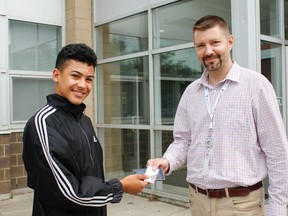 Jasiah Marshall (left), a Grade 10 student at Earl Haig Secondary School, meets Rob Dmochewicz after returning his lost cellphone and Metropass. (Daniel McKenzie/Toronto Sun)