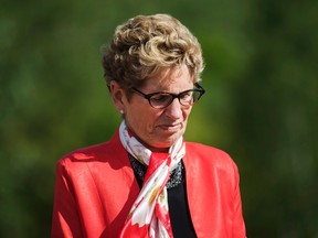 Ontario Premier Kathleen Wynne looks on before making a climate change policy announcement at Evergreen Brickworks in Toronto, Wednesday June 8, 2016. THE CANADIAN PRESS/Mark Blinch