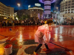 Protesters disperse color paint during a protest against the government, at central square, during an anti-government protest in Skopje on June 6, 2016, in a series of protests dubbed Colourful Revolution. AFP Photo/Robert ATANASOVSKI