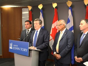 Mayor John Tory is flanked by Councillors Giorgio Mammoliti, Josh Colle and Vince Crisanti during a press conference to address gun violence in the city Wednesday, June 8, 2016. (SHAWN JEFFORDS/Toronto Sun)