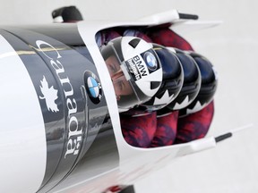 Driver Justin Kripps with Alexander Kopacz, Derek Plug and brakeman Ben Coakwell compete in the four-man bobsled World Cup race in Lake Placid, N.Y., on Jan. 9, 2016. Kripps, along with fellow bobsledder Chris Spring, are using the game of golf to improve their mental strength. (Mike Groll/AP Photo)